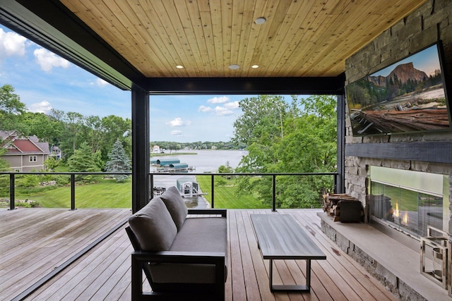 1300 Wildhurst Trl, Orono, MN 55364 - deck featuring an outdoor stone fireplace and view of wooded area