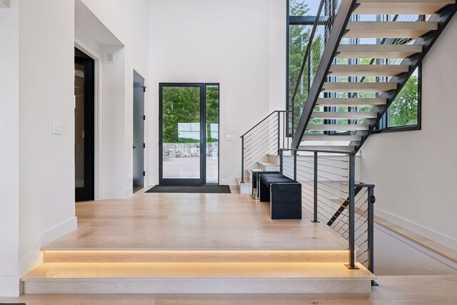 1300 Wildhurst Trl, Orono, MN 55364 - foyer entrance with stairway, wood finished floors, and a towering ceiling