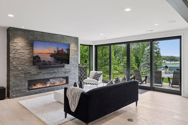 1300 Wildhurst Trl, Orono, MN 55364 - living area featuring healthy amount of natural light, wood finished floors, a fireplace, and recessed lighting