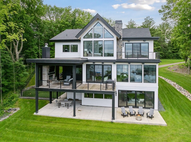 1300 Wildhurst Trl, Orono, MN 55364 - back of house featuring a chimney, a balcony, a patio area, and a lawn