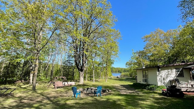 14364 Hummingbird Trl, Bay Lake Twp, MN 56444 - view of green lawn featuring an outdoor fire pit and a water view