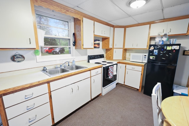 14364 Hummingbird Trl, Bay Lake Twp, MN 56444 - kitchen with white appliances, light countertops, a drop ceiling, light colored carpet, and white cabinetry