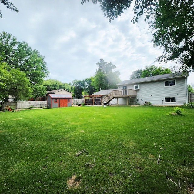 306 Parkview Curv, Zumbrota, MN 55992 - view of yard featuring stairway, a deck, and a storage unit