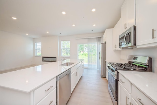 6266 205th St N, Forest Lake, MN 55025 - kitchen with appliances with stainless steel finishes, recessed lighting, an island with sink, white cabinetry, and light wood-type flooring