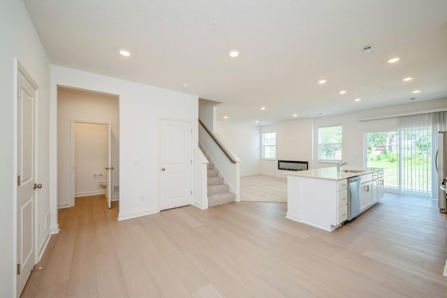 6266 205th St N, Forest Lake, MN 55025 - kitchen with stainless steel dishwasher, light wood-style floors, open floor plan, recessed lighting, and light countertops