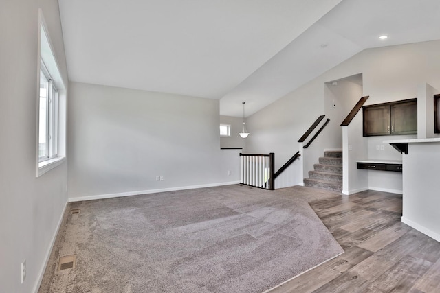 9854 187th Ln NW, Elk River, MN 55330 - unfurnished living room with vaulted ceiling and wood finished floors