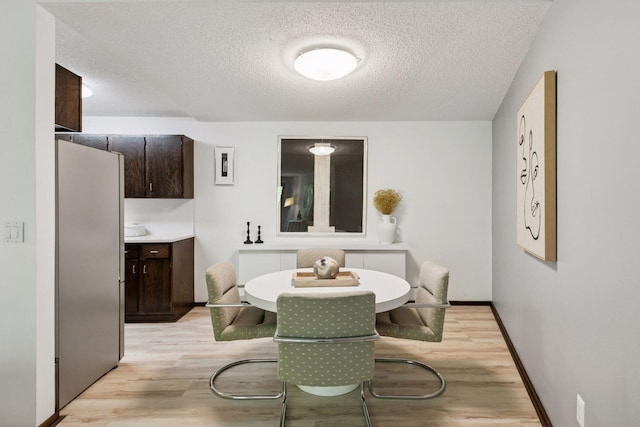1200 Nicollet Mall Unit 409, Minneapolis, MN 55403 - dining room featuring a textured ceiling and light wood finished floors