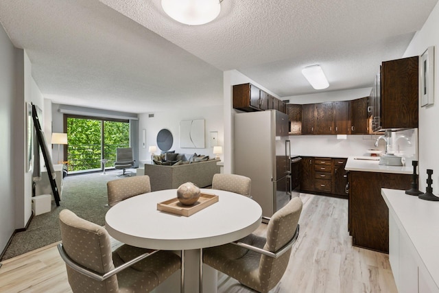 1200 Nicollet Mall Unit 409, Minneapolis, MN 55403 - dining room with light wood finished floors and a textured ceiling