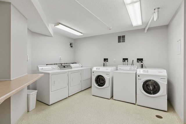 1200 Nicollet Mall Unit 409, Minneapolis, MN 55403 - community laundry room with washing machine and clothes dryer and a textured ceiling