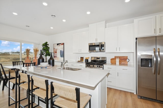 14388 Allerton Way, Rosemount, MN 55068 - kitchen with appliances with stainless steel finishes, light countertops, a kitchen island with sink, white cabinets, and recessed lighting