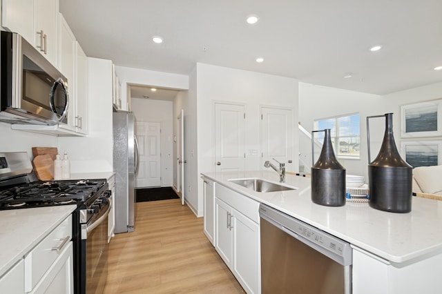 14388 Allerton Way, Rosemount, MN 55068 - kitchen featuring stainless steel appliances, a kitchen island with sink, light wood-style floors, white cabinets, and recessed lighting