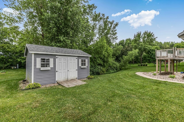 662 Cottonwood Ave, Litchfield, MN 55355 - view of green lawn featuring an outdoor structure, a deck, and view of scattered trees