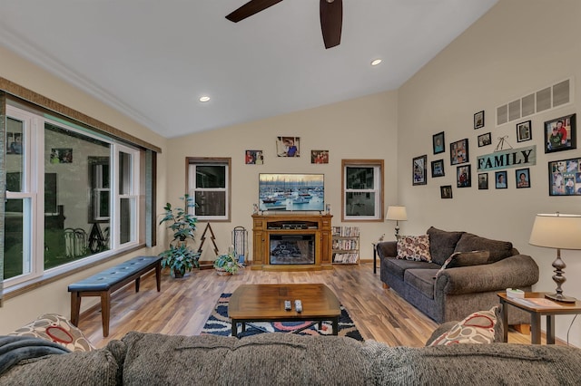 662 Cottonwood Ave, Litchfield, MN 55355 - living area with wood finished floors, a ceiling fan, vaulted ceiling, a glass covered fireplace, and recessed lighting