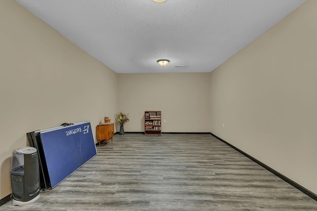 662 Cottonwood Ave, Litchfield, MN 55355 - unfurnished room featuring wood finished floors and a textured ceiling
