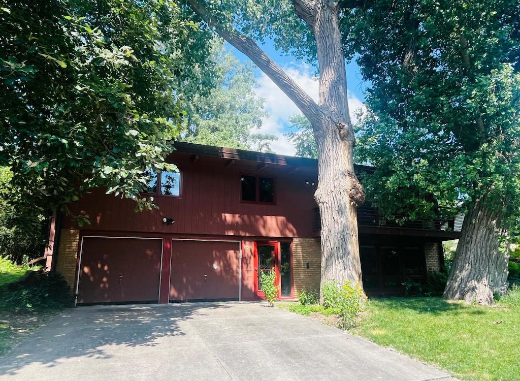 626 Desnoyer Ave, Saint Paul, MN 55104 - view of front of home featuring brick siding, a garage, and driveway
