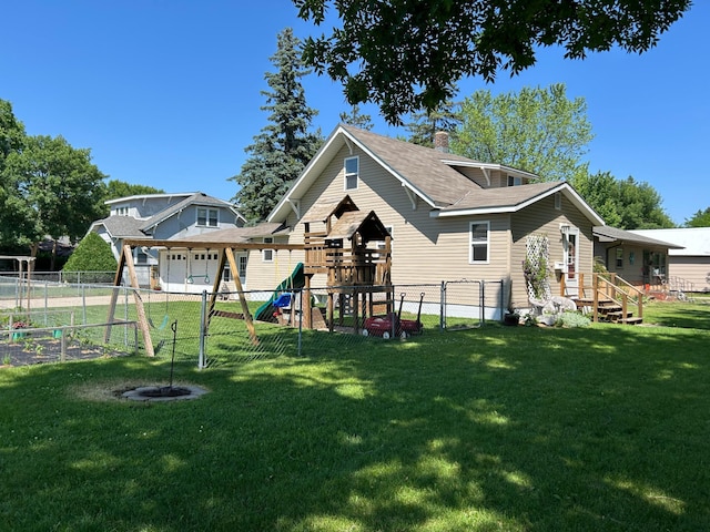20 King Ave SW, Wadena, MN 56482 - rear view of house with a playground, a fenced backyard, and a chimney
