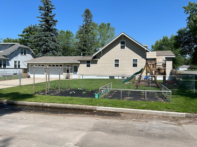 20 King Ave SW, Wadena, MN 56482 - view of front of house with concrete driveway, a garage, and a playground