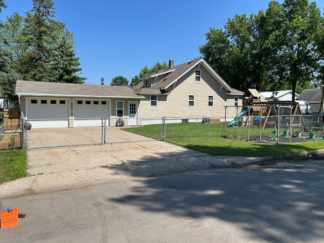 20 King Ave SW, Wadena, MN 56482 - view of front of home featuring a playground, a garage, driveway, and a gate
