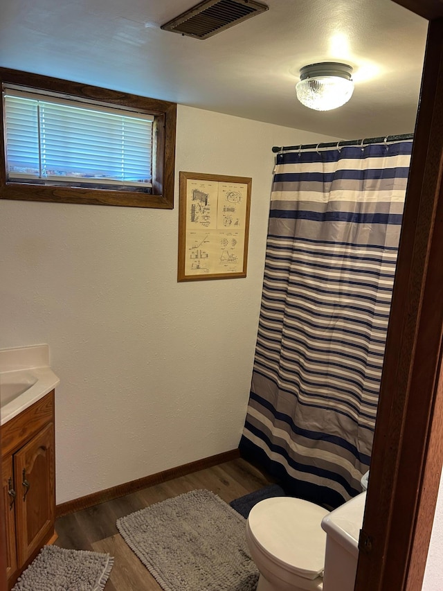 20 King Ave SW, Wadena, MN 56482 - bathroom with vanity, wood finished floors, and curtained shower