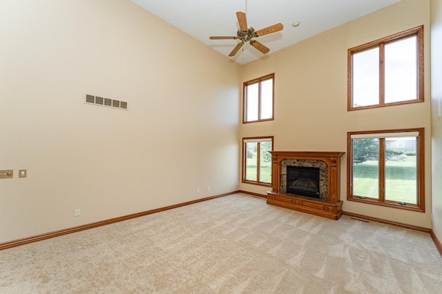 1608 Greystone Ln SW, Rochester, MN 55902 - unfurnished living room featuring light carpet, high vaulted ceiling, a premium fireplace, and a ceiling fan