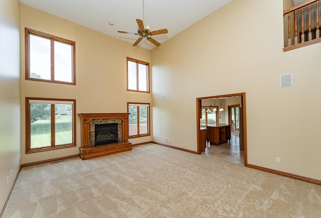1608 Greystone Ln SW, Rochester, MN 55902 - unfurnished living room with high vaulted ceiling, carpet flooring, a ceiling fan, a high end fireplace, and plenty of natural light