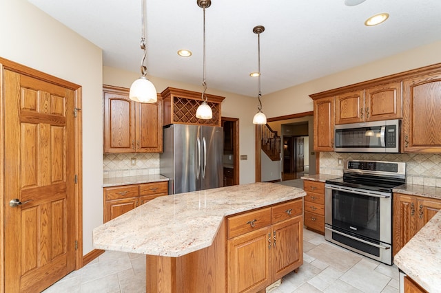 1608 Greystone Ln SW, Rochester, MN 55902 - kitchen with appliances with stainless steel finishes, backsplash, a center island, light stone countertops, and hanging light fixtures