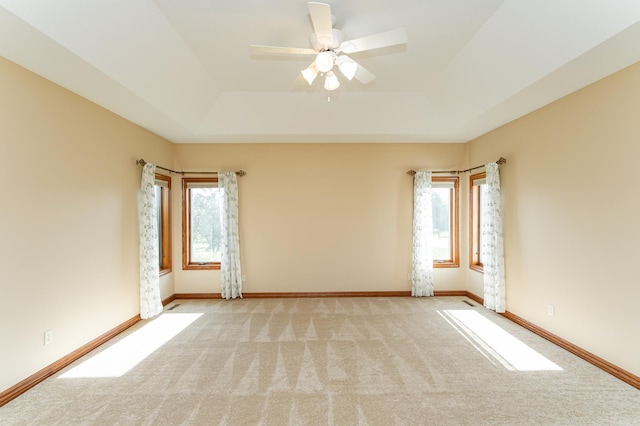1608 Greystone Ln SW, Rochester, MN 55902 - spare room with a raised ceiling, plenty of natural light, carpet, and a ceiling fan