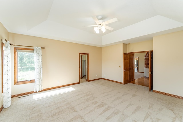 1608 Greystone Ln SW, Rochester, MN 55902 - spare room with light carpet, ceiling fan, and a tray ceiling