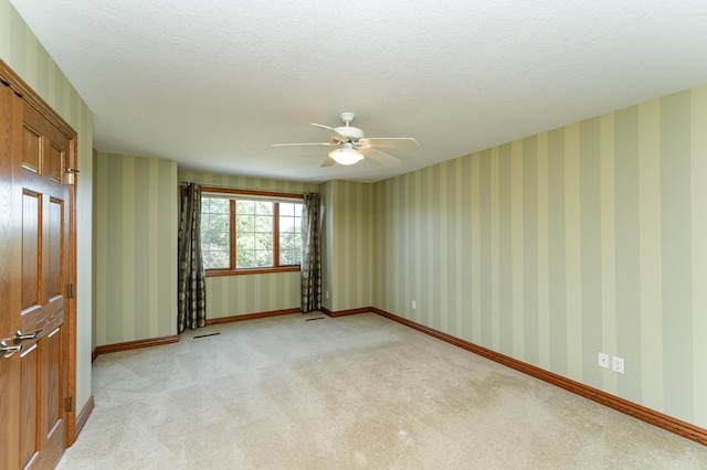 1608 Greystone Ln SW, Rochester, MN 55902 - empty room with light colored carpet, ceiling fan, and a textured ceiling