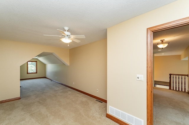 1608 Greystone Ln SW, Rochester, MN 55902 - additional living space with carpet floors, a ceiling fan, and a textured ceiling