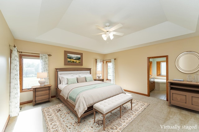 1608 Greystone Ln SW, Rochester, MN 55902 - bedroom with a tray ceiling, light carpet, multiple windows, and connected bathroom