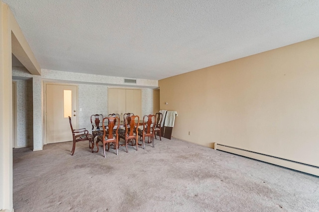 2485 Canabury Dr Unit 116, Little Canada, MN 55117 - dining room featuring carpet floors, a textured ceiling, and a baseboard heating unit