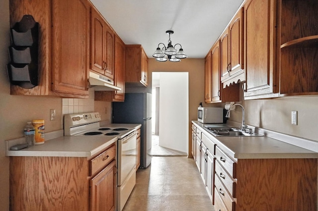 2485 Canabury Dr Unit 116, Little Canada, MN 55117 - kitchen featuring white appliances, under cabinet range hood, a chandelier, light countertops, and brown cabinetry
