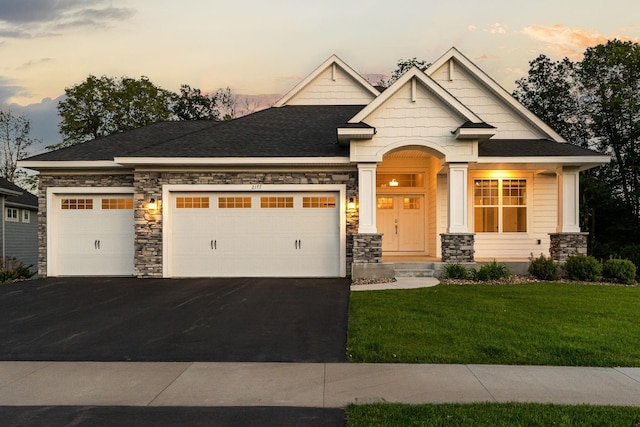 2177 Paisley Path, Chanhassen, MN 55317 - craftsman-style house featuring driveway, a garage, stone siding, a lawn, and a shingled roof