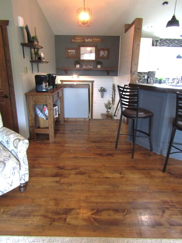 1103 15th St, Montevideo, MN 56265 - kitchen featuring wood finished floors, pendant lighting, and backsplash