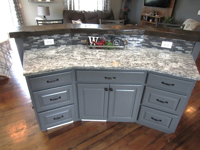 1103 15th St, Montevideo, MN 56265 - kitchen featuring gray cabinets, dark wood finished floors, and light stone counters