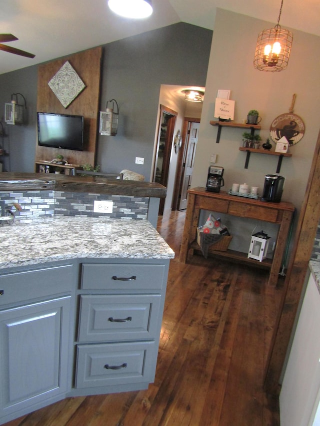 1103 15th St, Montevideo, MN 56265 - kitchen with vaulted ceiling, dark wood-style flooring, ceiling fan, and light stone counters