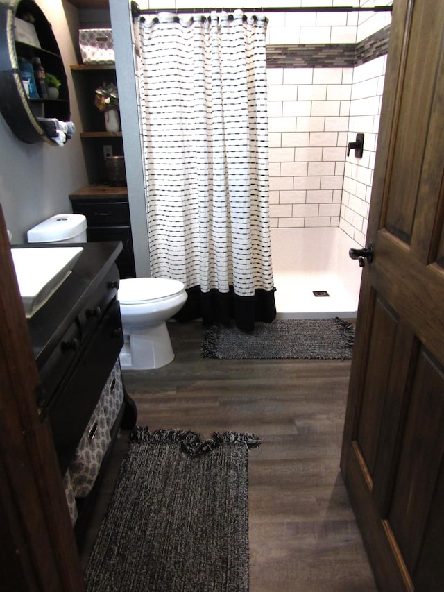 1103 15th St, Montevideo, MN 56265 - bathroom with vanity, a shower with shower curtain, and wood finished floors