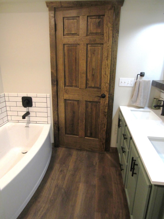 1103 15th St, Montevideo, MN 56265 - bathroom featuring wood finished floors, a bath, and double vanity