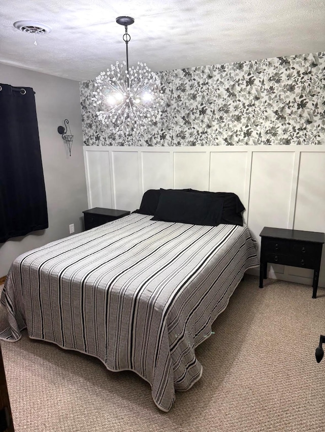 1103 15th St, Montevideo, MN 56265 - carpeted bedroom featuring a chandelier, a wainscoted wall, a decorative wall, and a textured ceiling