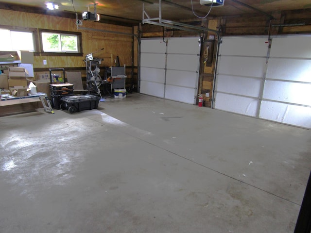 1103 15th St, Montevideo, MN 56265 - garage featuring a garage door opener and wooden walls