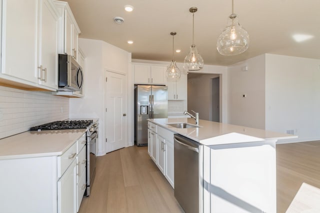 15149 Quince St NW, Andover, MN 55304 - kitchen with appliances with stainless steel finishes, light wood-style flooring, white cabinetry, tasteful backsplash, and recessed lighting