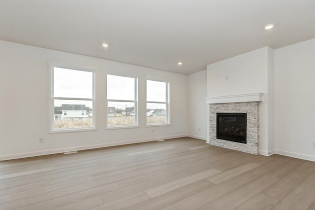 4021 Heath Ln N, Oakdale, MN 55128 - unfurnished living room featuring light wood-type flooring, a fireplace, and recessed lighting