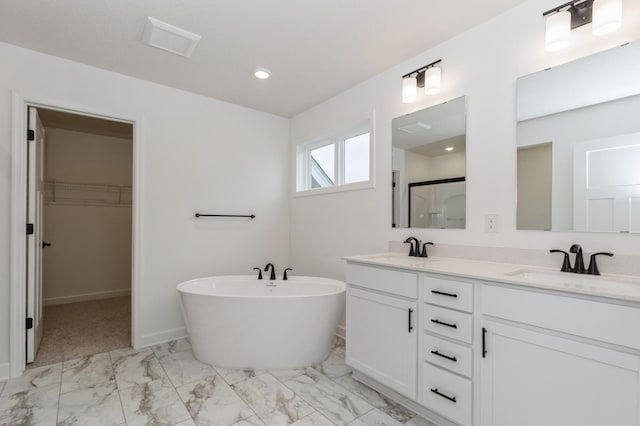 4021 Heath Ln N, Oakdale, MN 55128 - bathroom with marble finish floors, double vanity, a spacious closet, a shower stall, and a soaking tub