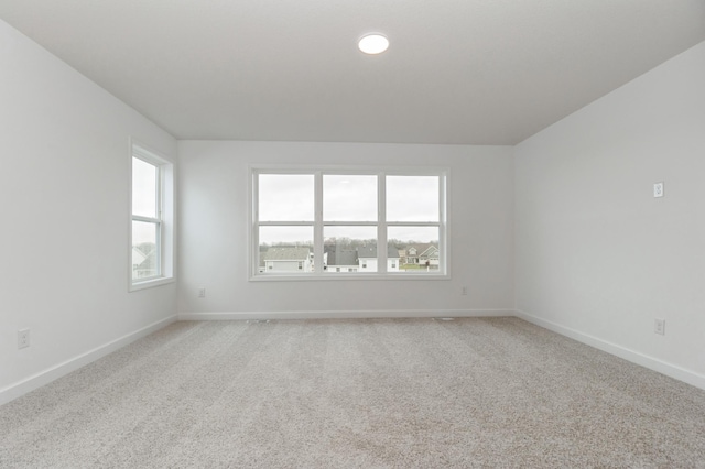 4021 Heath Ln N, Oakdale, MN 55128 - spare room featuring healthy amount of natural light and light carpet