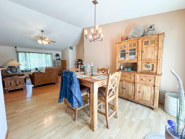 915 Stanton Ave, Fergus Falls, MN 56537 - dining room featuring light wood finished floors, ceiling fan, a chandelier, and lofted ceiling