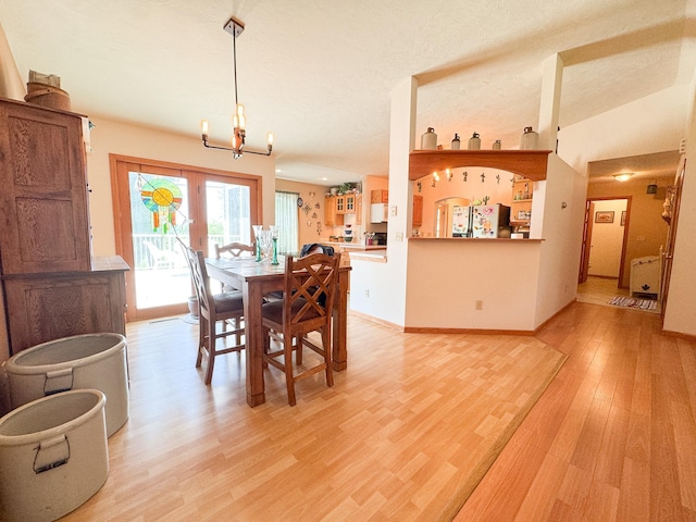 915 Stanton Ave, Fergus Falls, MN 56537 - dining area featuring light wood-style floors, a chandelier, and radiator