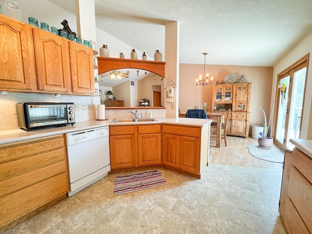 915 Stanton Ave, Fergus Falls, MN 56537 - kitchen with white dishwasher, decorative backsplash, a chandelier, light countertops, and lofted ceiling