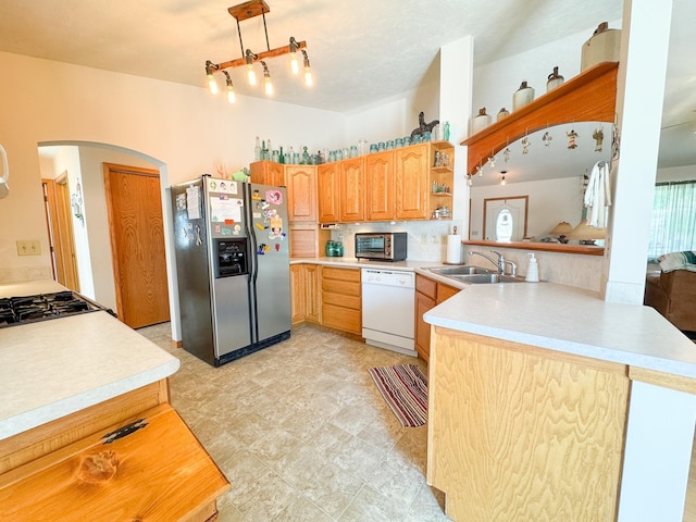 915 Stanton Ave, Fergus Falls, MN 56537 - kitchen with stainless steel refrigerator with ice dispenser, dishwasher, arched walkways, light countertops, and a peninsula