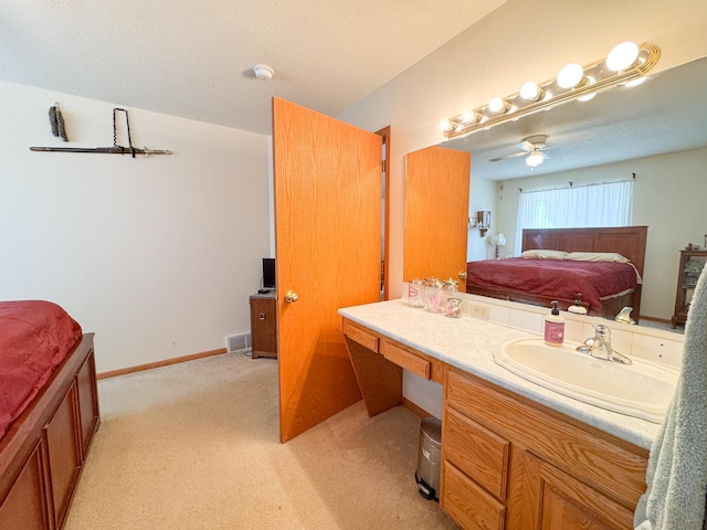 915 Stanton Ave, Fergus Falls, MN 56537 - bathroom with ensuite bathroom, vanity, ceiling fan, and a textured ceiling